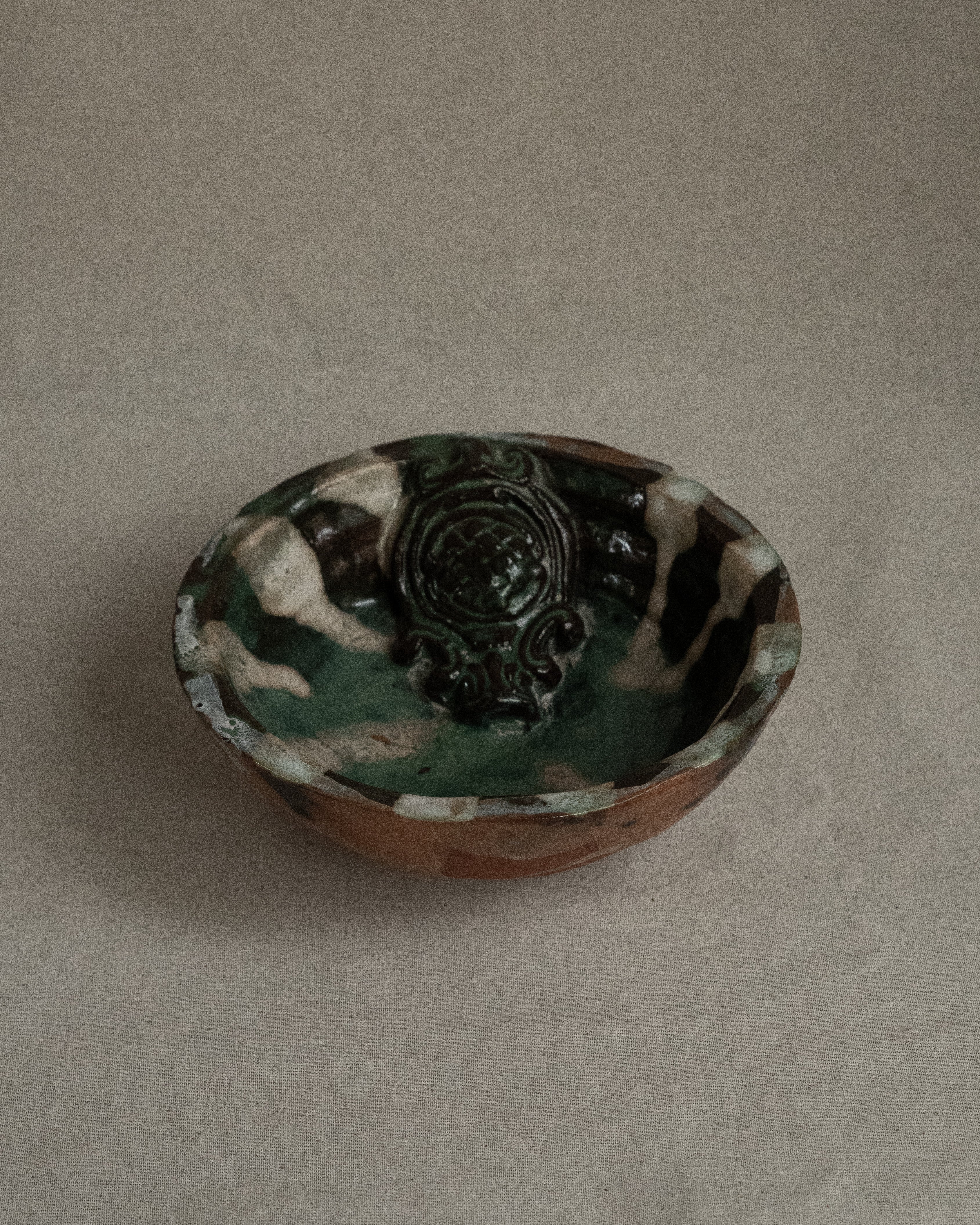 Ceramic bowl with green blue white brown hues