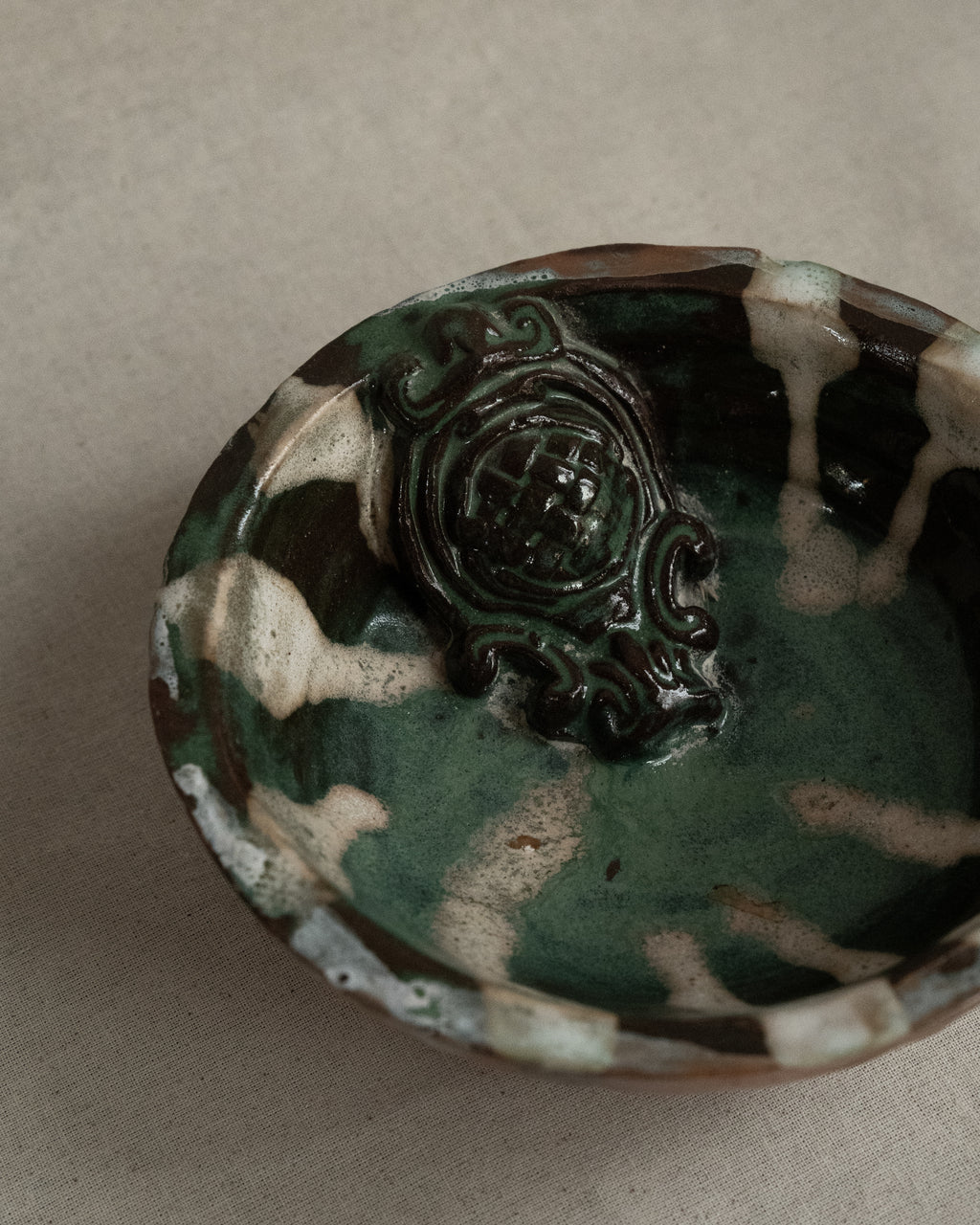 Ceramic bowl with green blue white brown hues