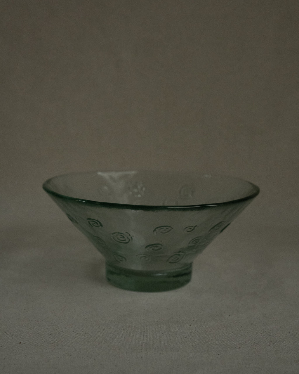Tinted green glass bowl with spirals