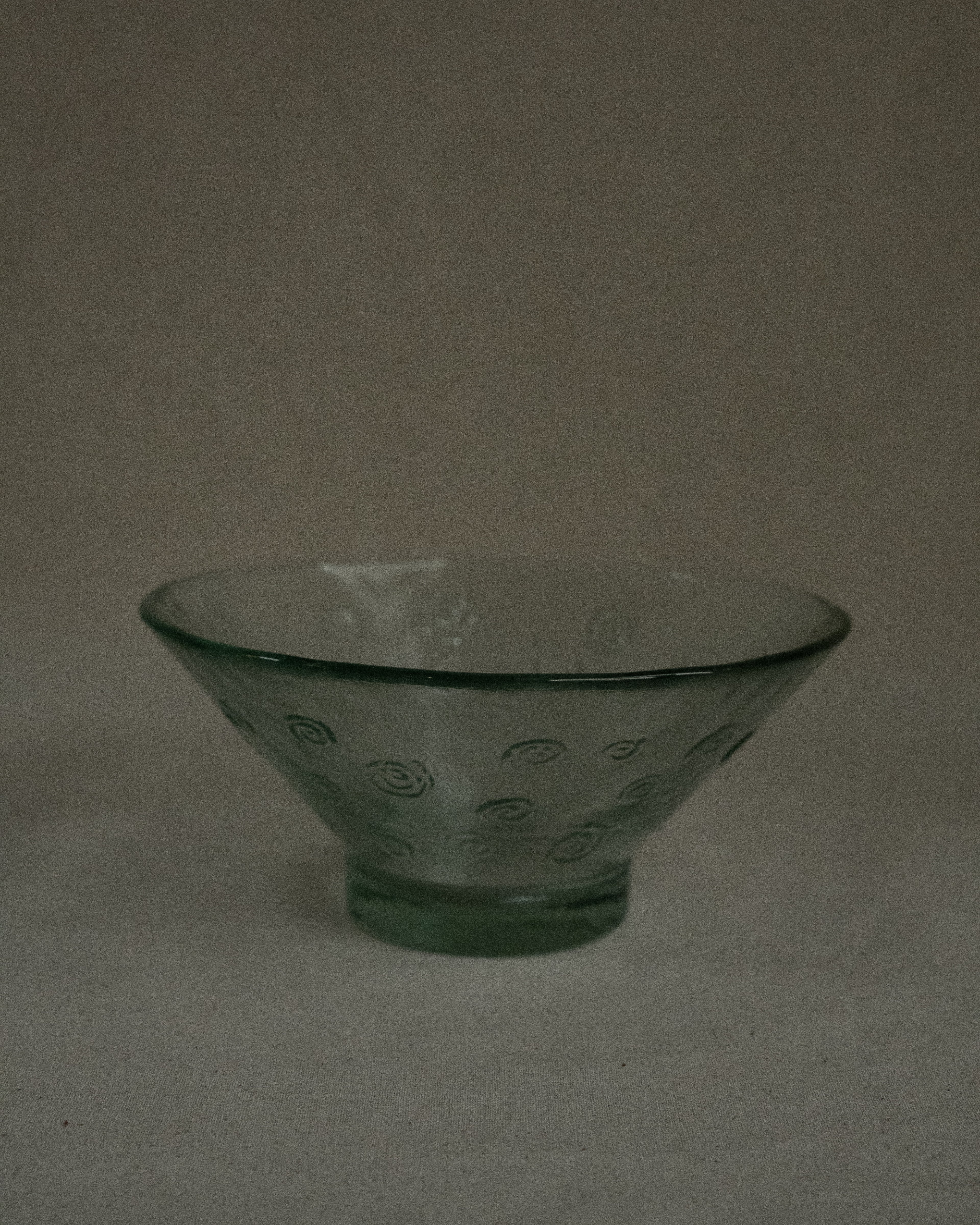 Tinted green glass bowl with spirals