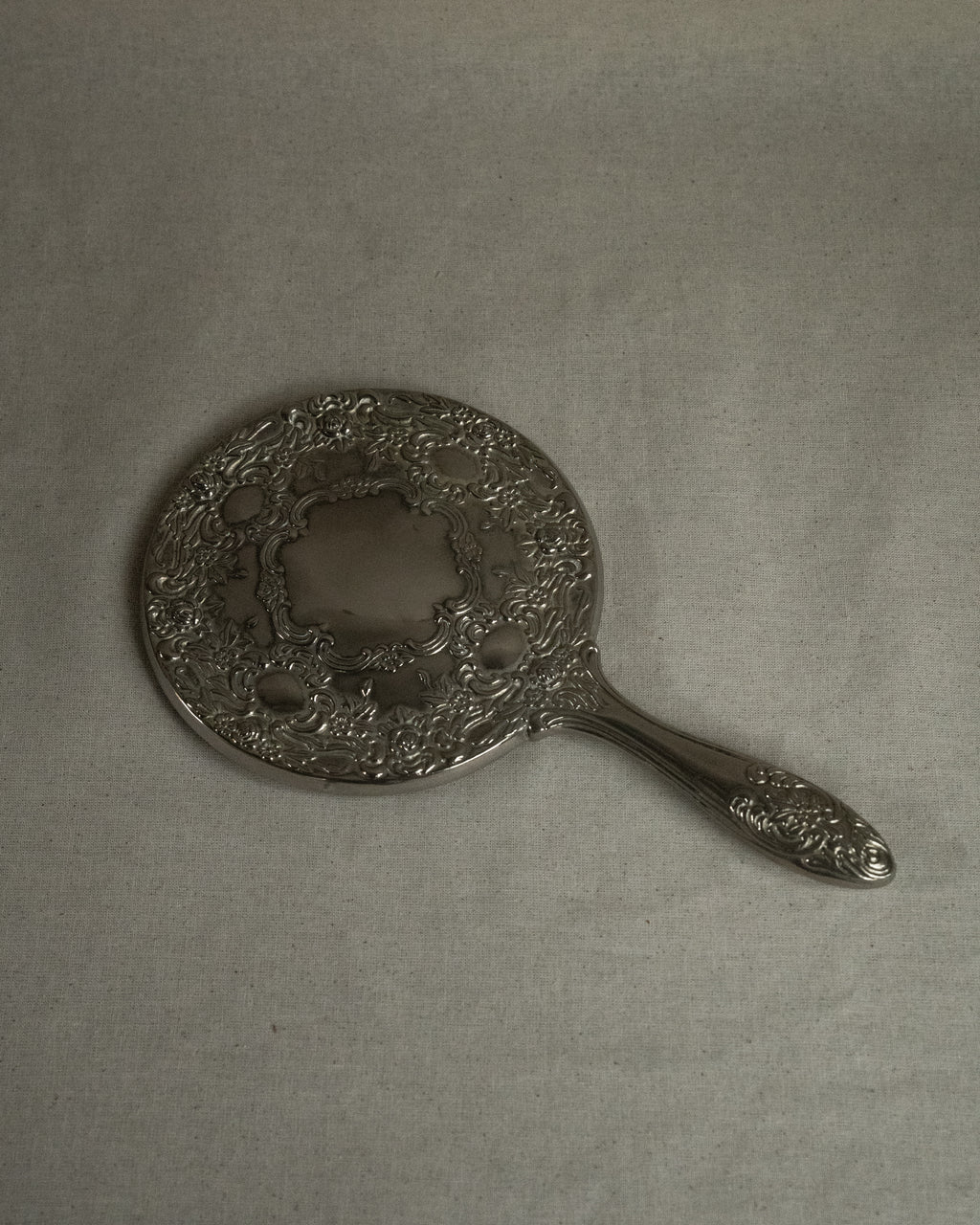 Silver plated ornate handheld mirror