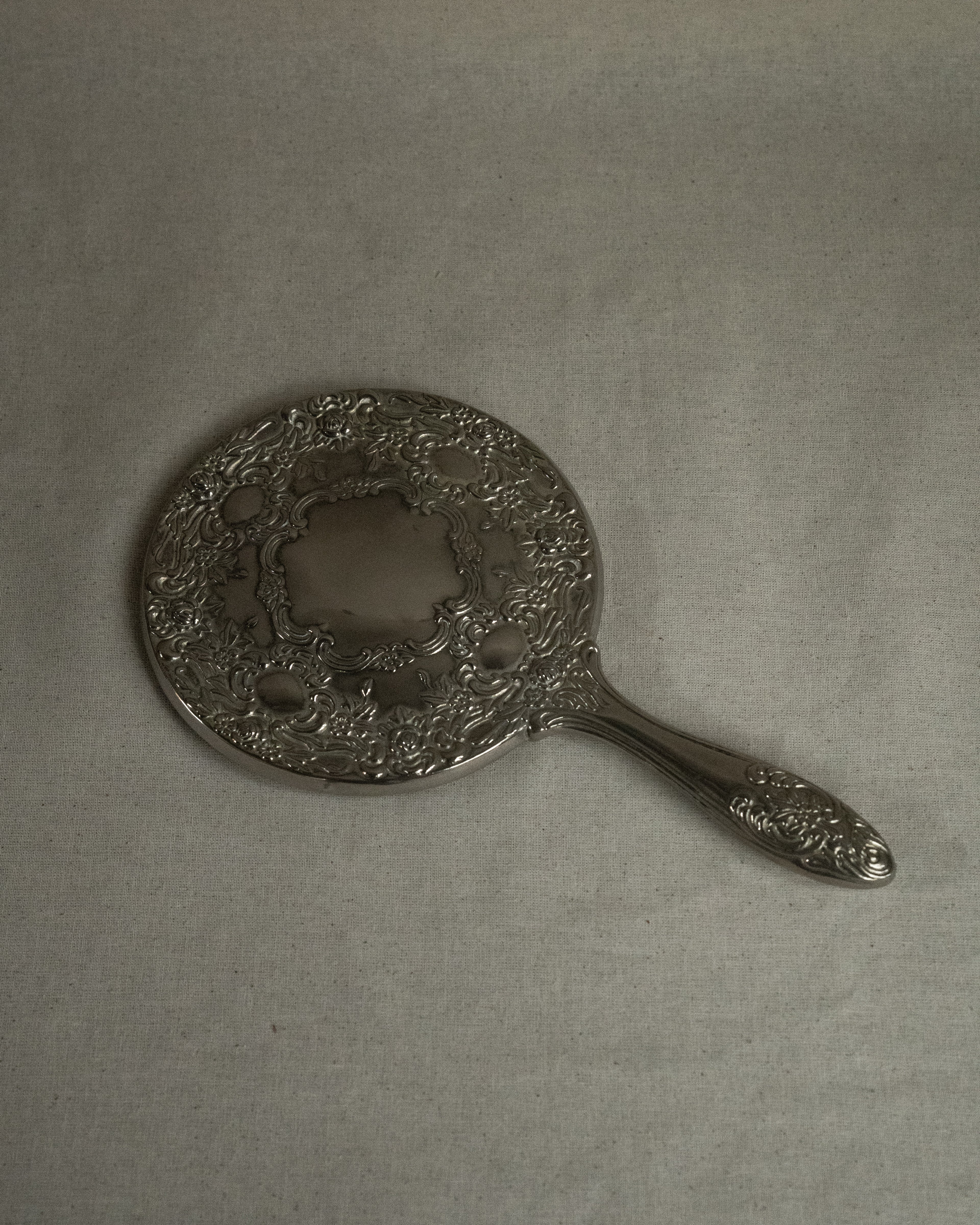 Silver plated ornate handheld mirror