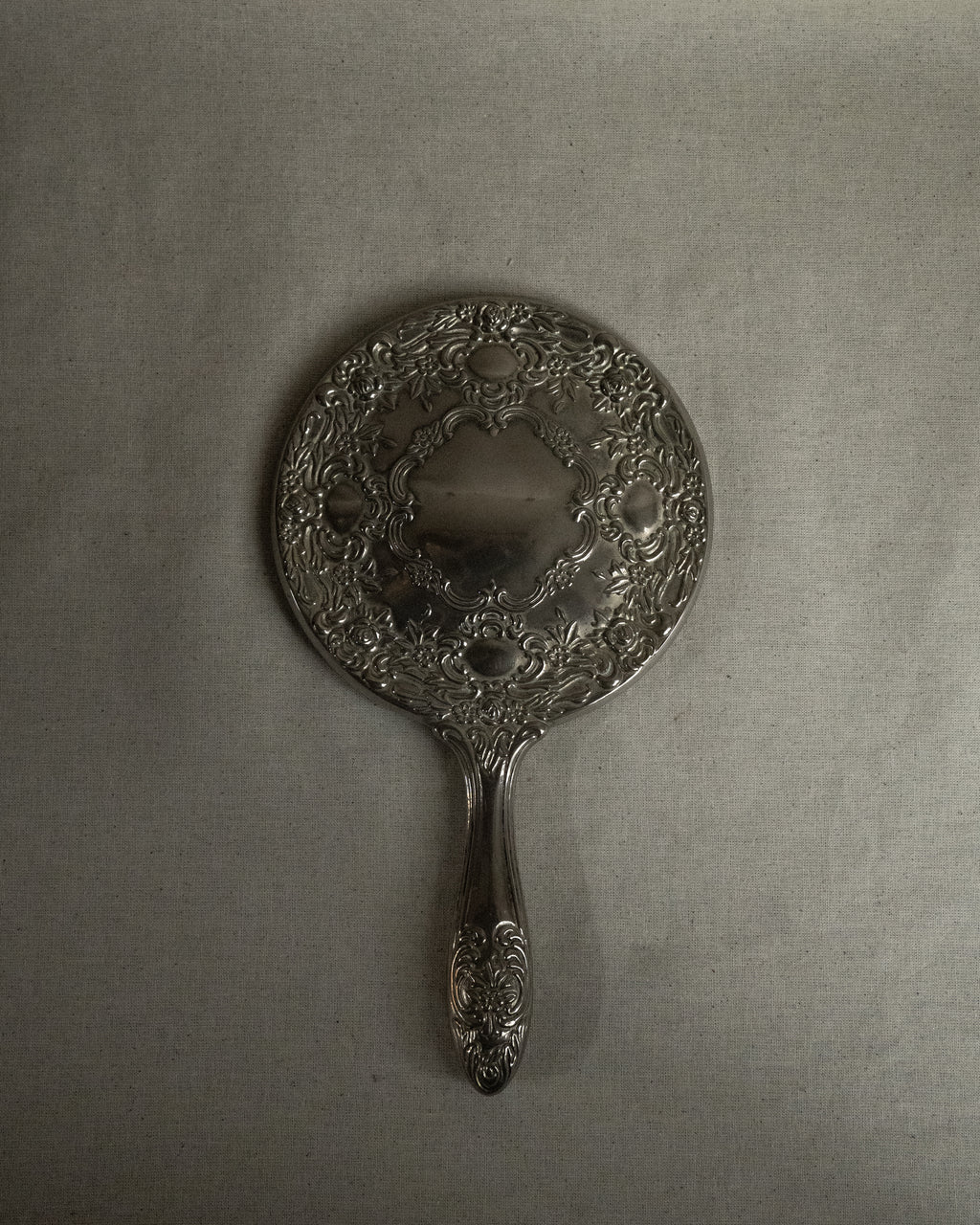 Silver plated ornate handheld mirror