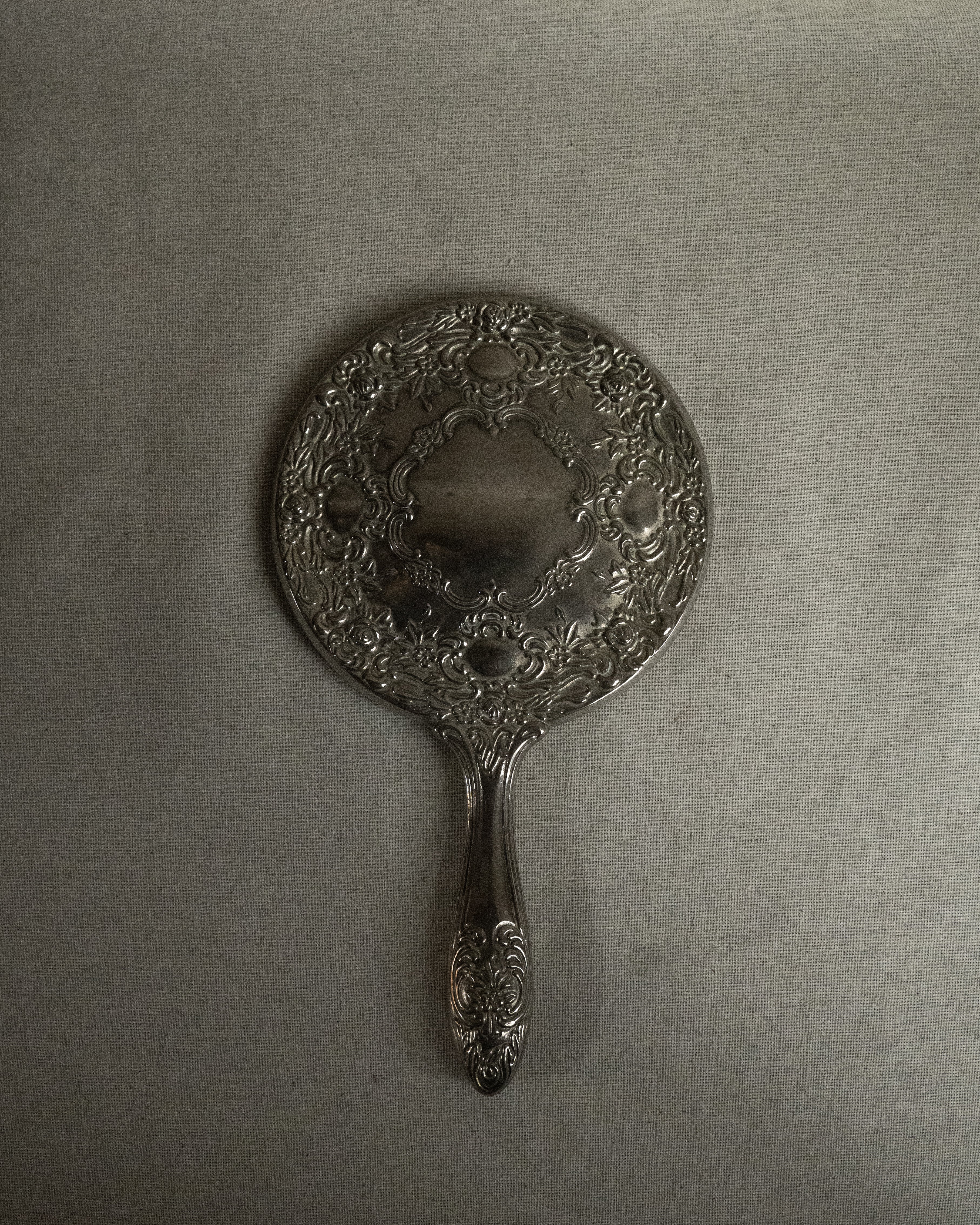 Silver plated ornate handheld mirror