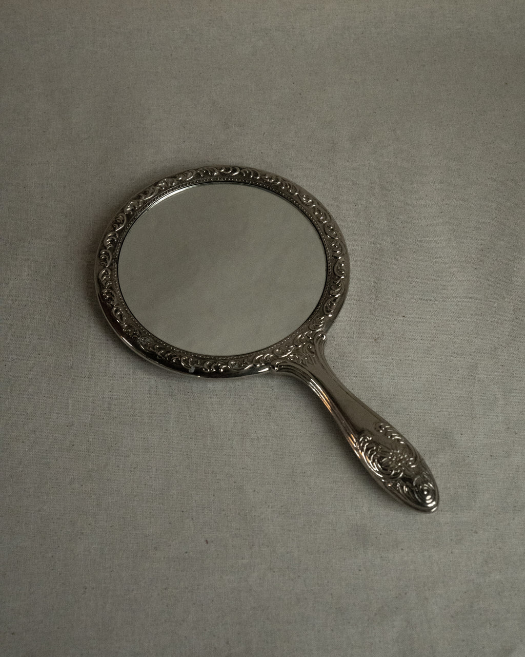 Silver plated ornate handheld mirror