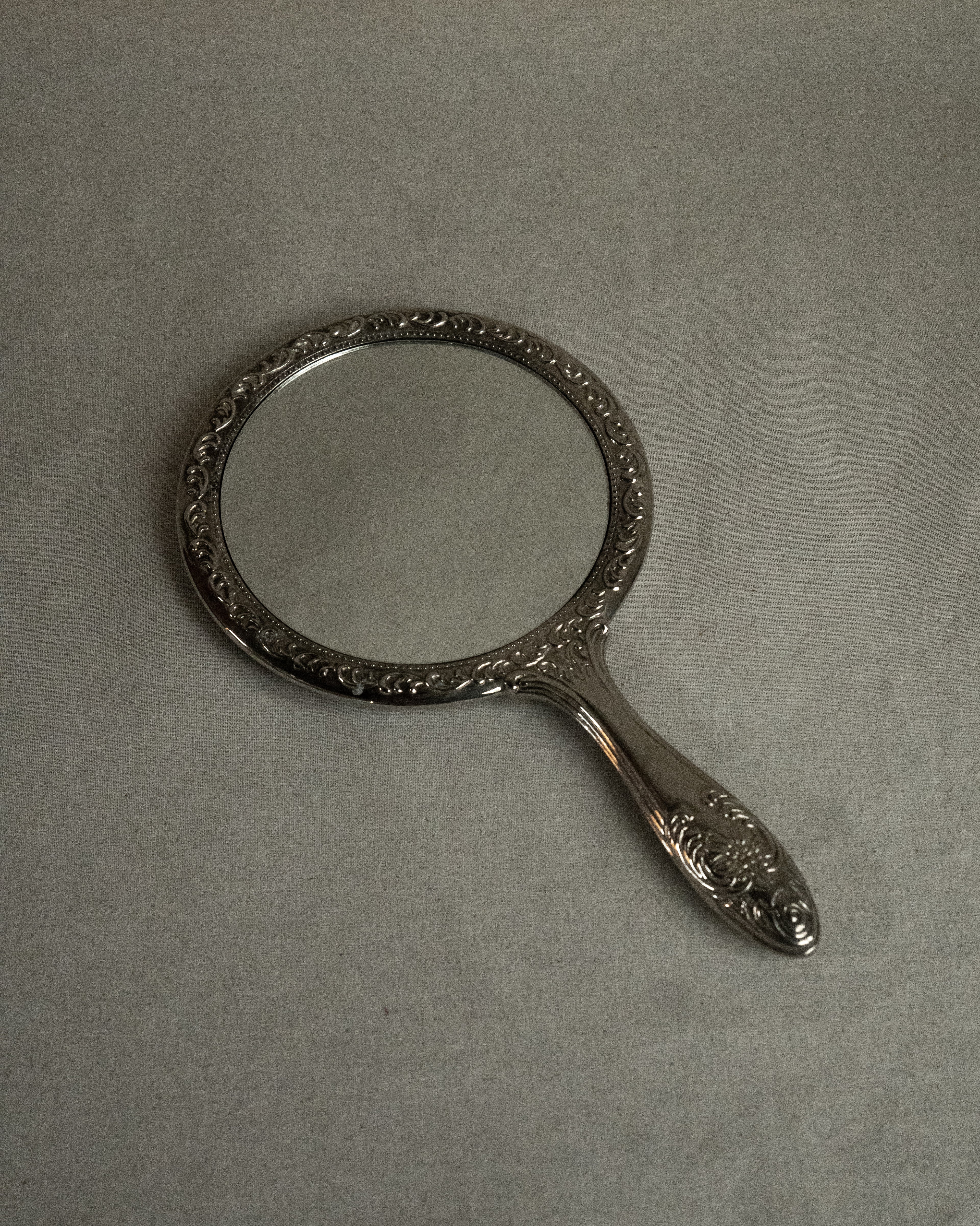 Silver plated ornate handheld mirror