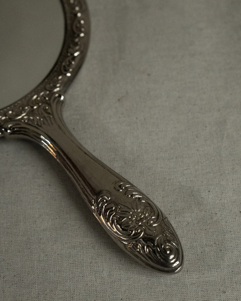 Silver plated ornate handheld mirror
