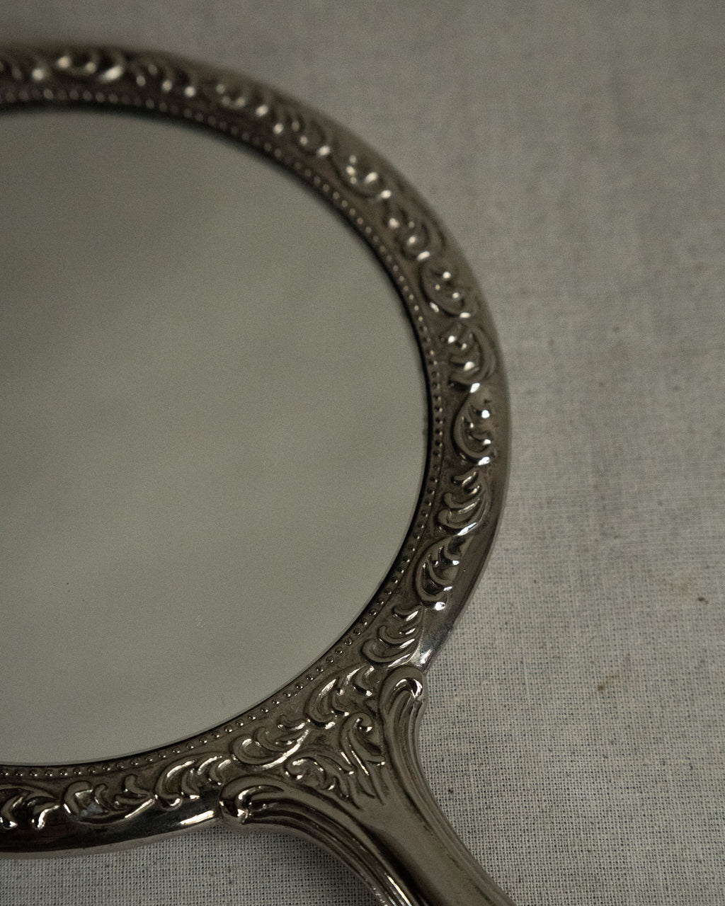 Silver plated ornate handheld mirror