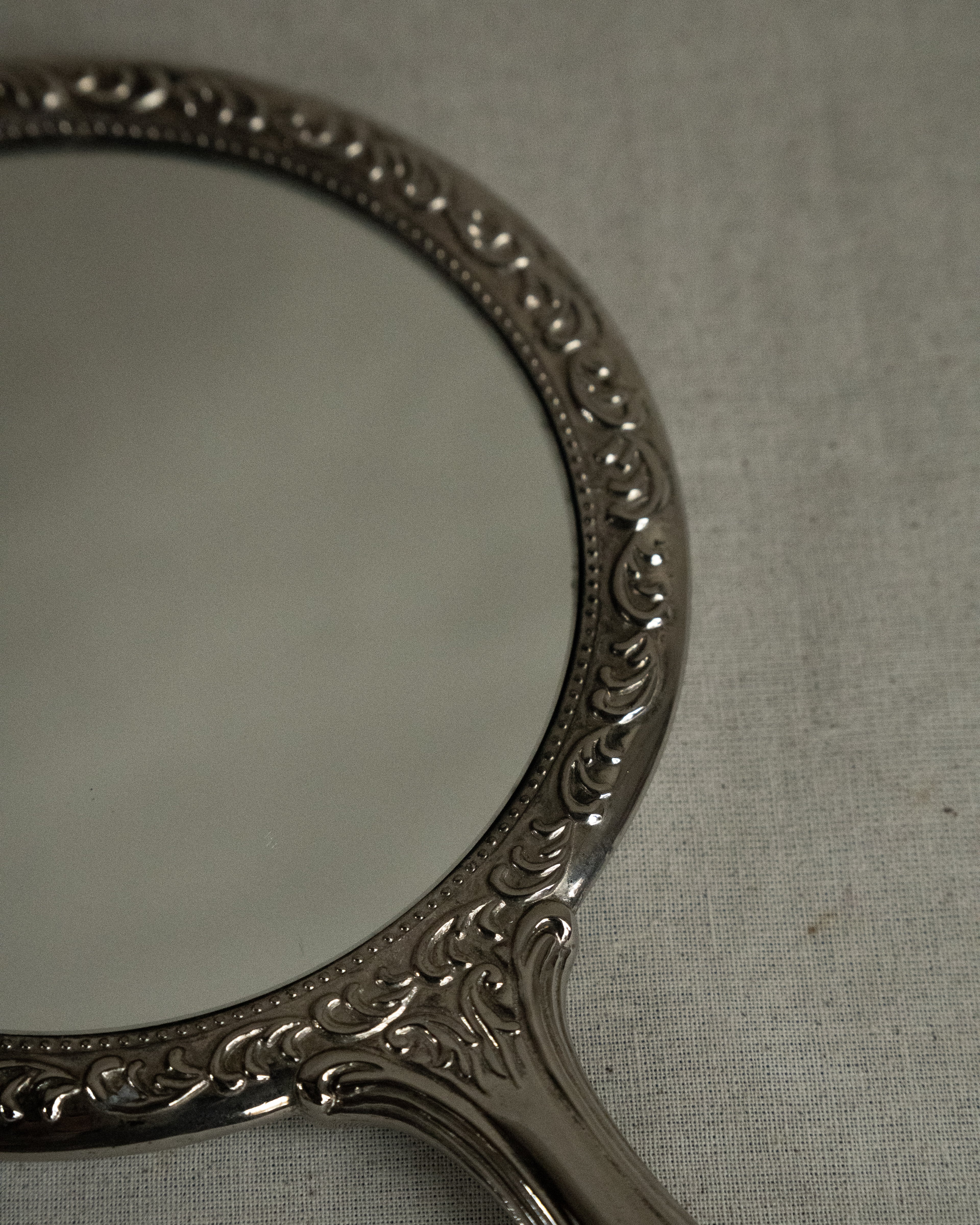 Silver plated ornate handheld mirror