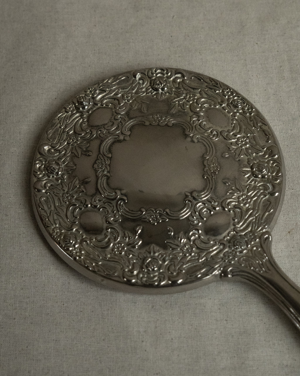 Silver plated ornate handheld mirror