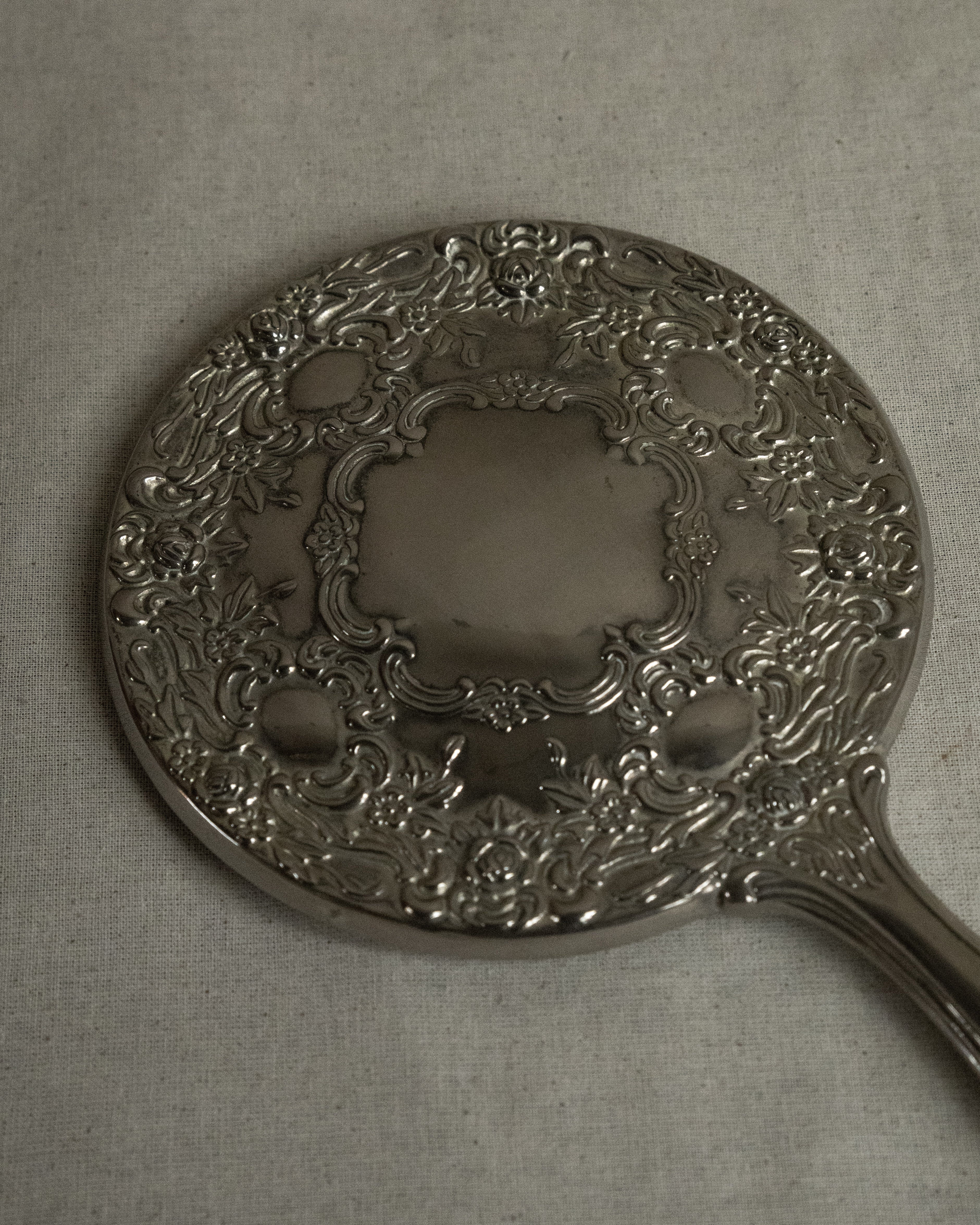 Silver plated ornate handheld mirror