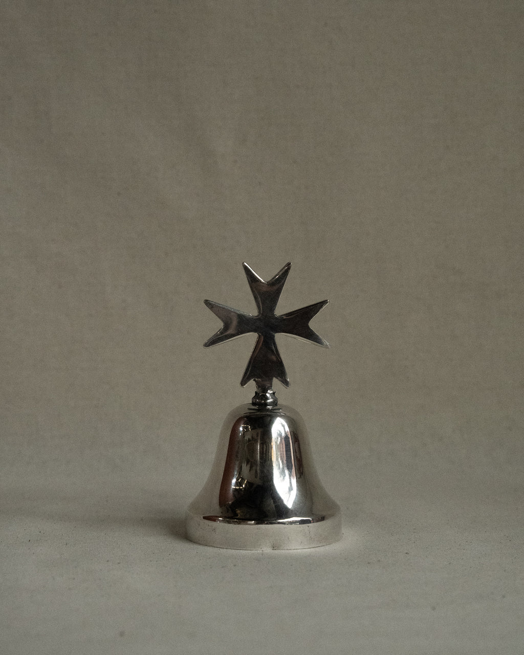 Silver plated bell with cross