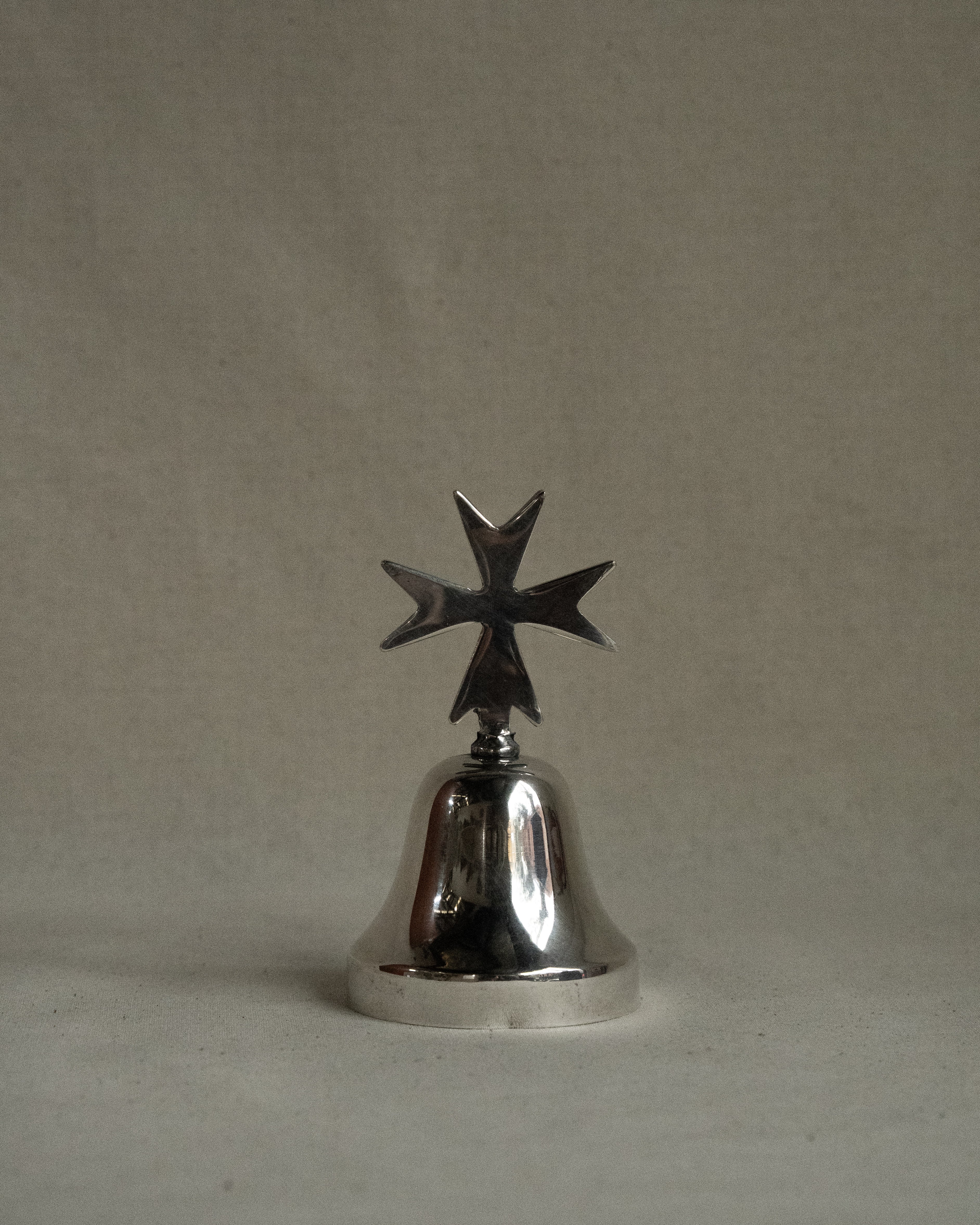 Silver plated bell with cross