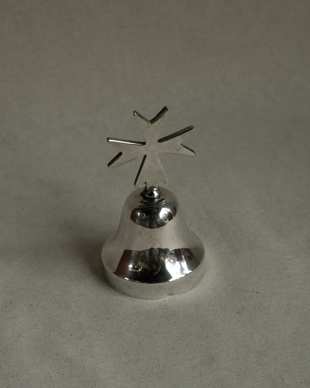 Silver plated bell with cross
