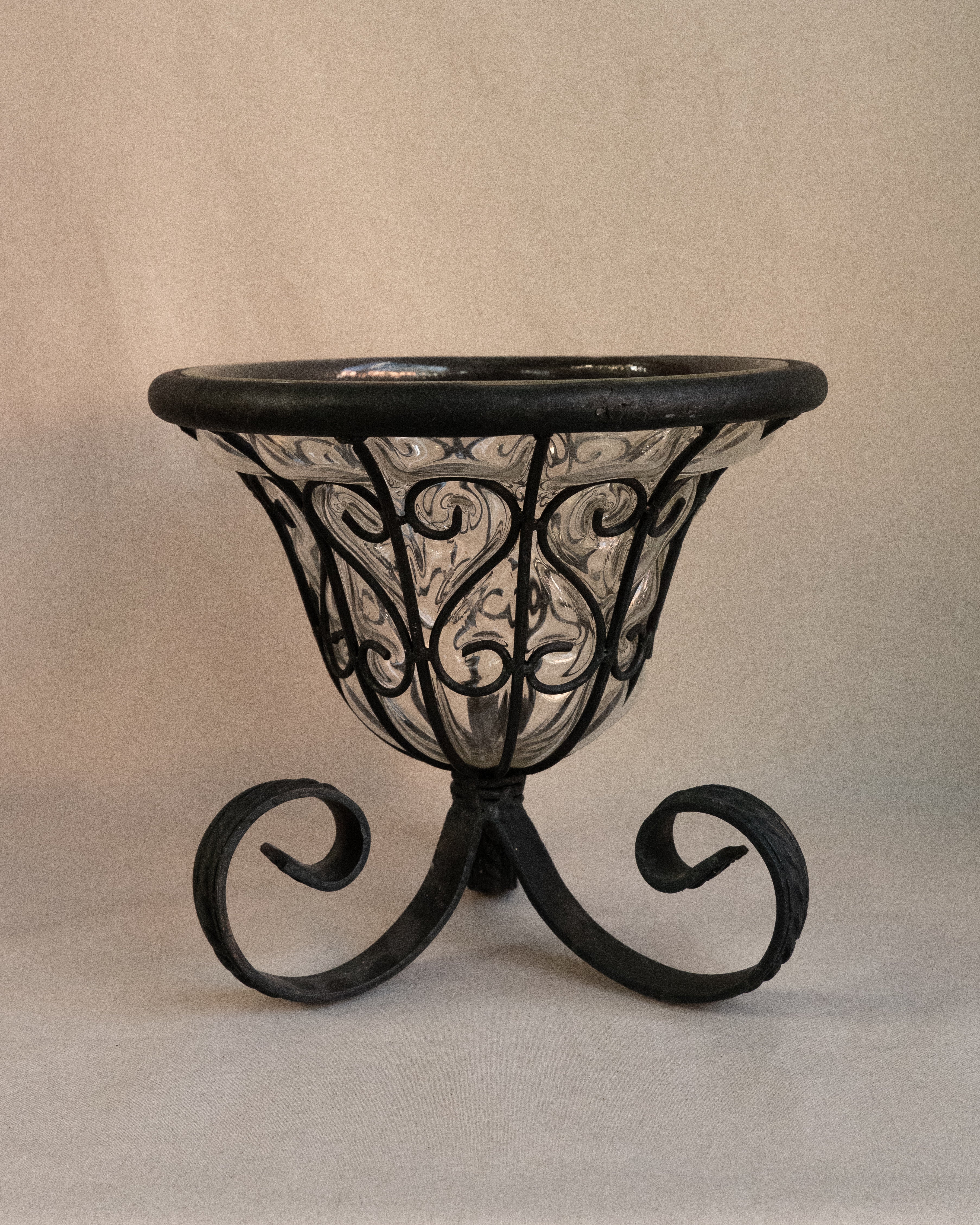 Glass bubble vessel in wrought iron cage and spiral feet