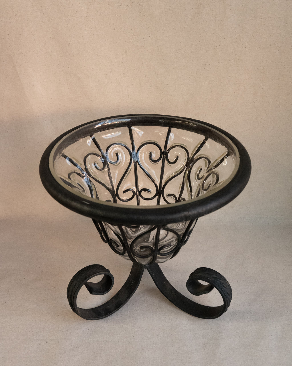Glass bubble vessel in wrought iron cage and spiral feet