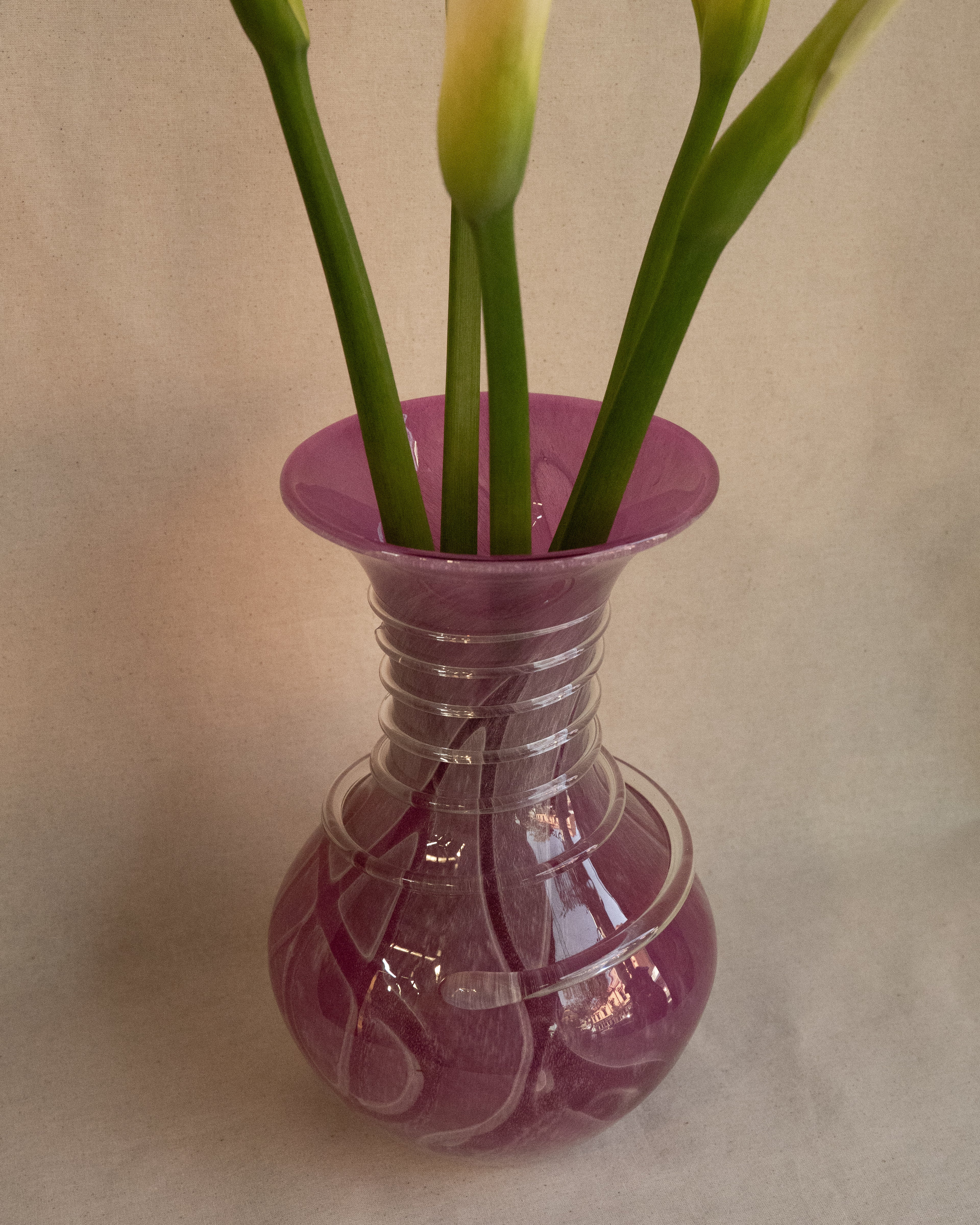 Pink art glass vase with external trailing