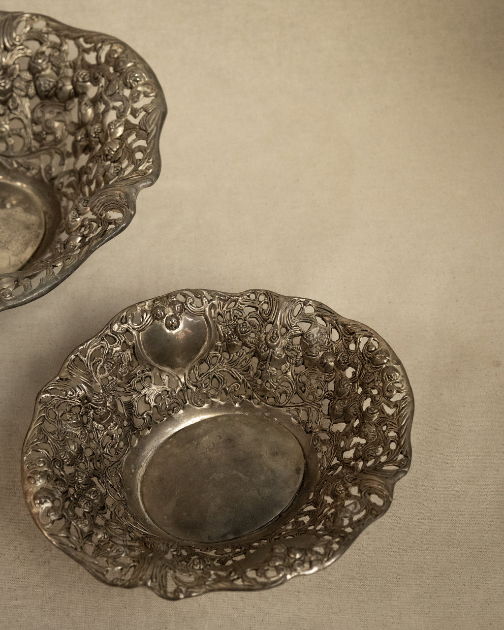 Pair of silver finish bowls with rose details
