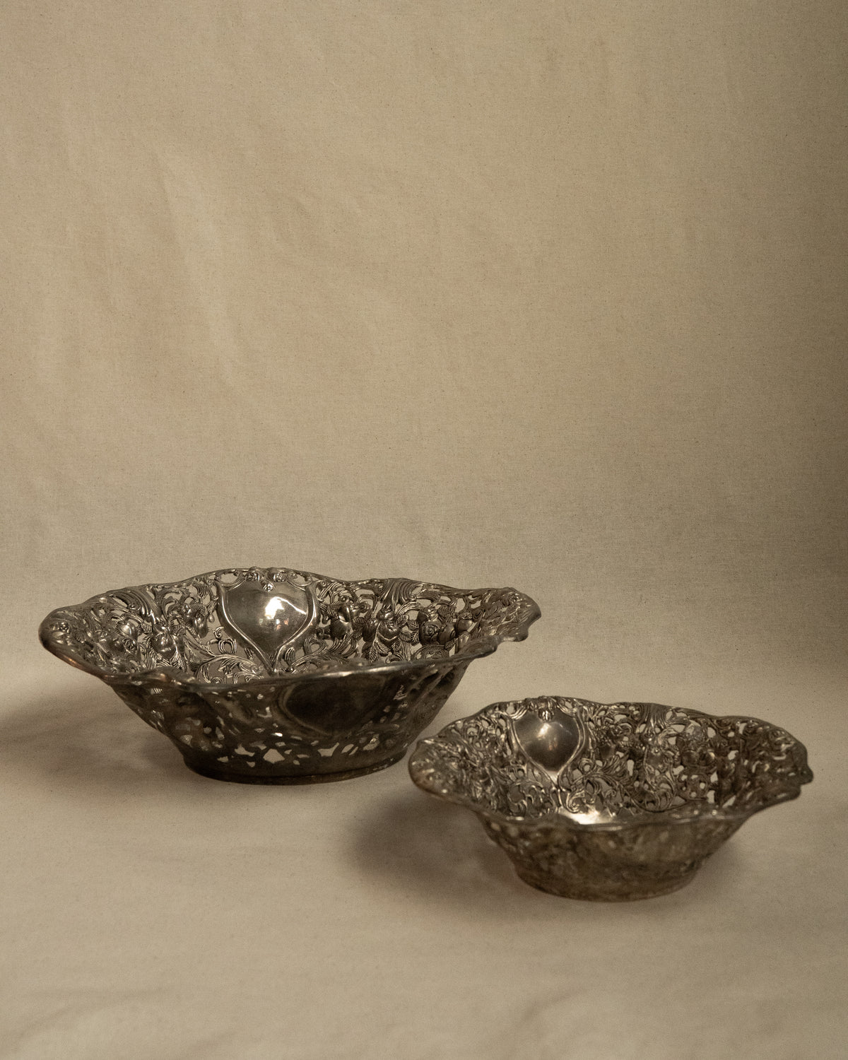 Pair of silver finish bowls with rose details