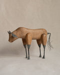 Folk art carved wooden bull with metal details