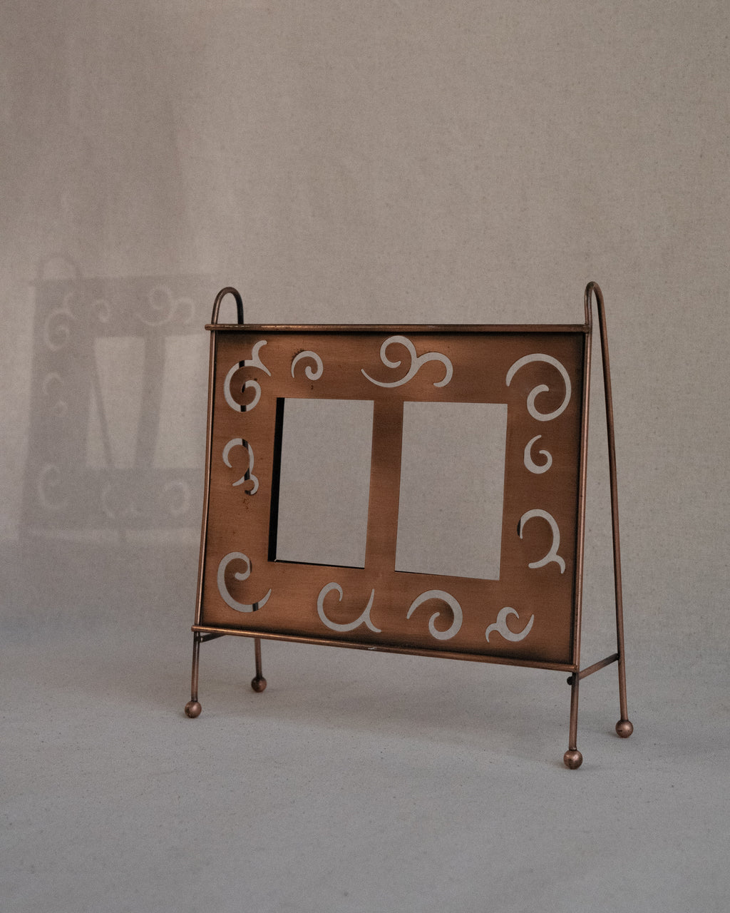 Copper finish dual picture frame with spiral cutouts