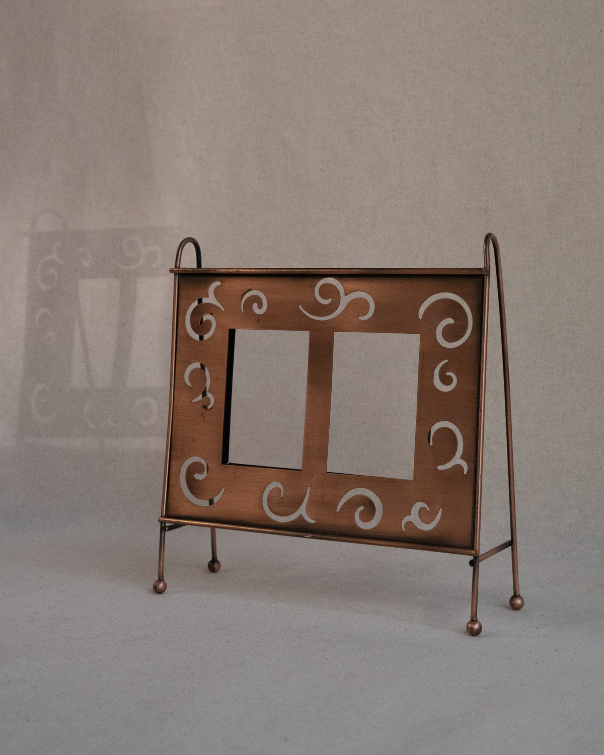 Copper finish dual picture frame with spiral cutouts
