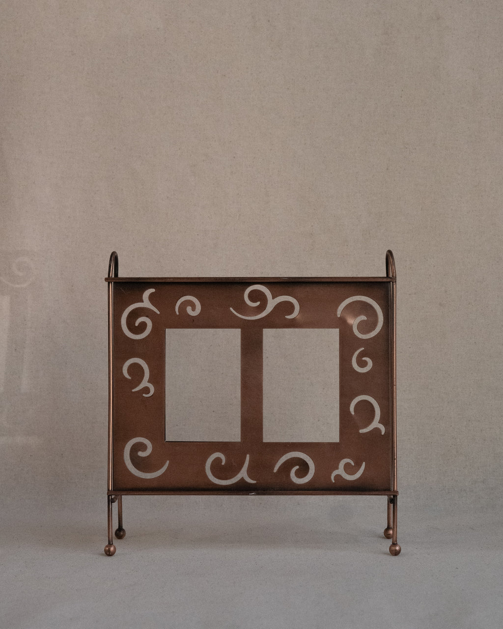 Copper finish dual picture frame with spiral cutouts