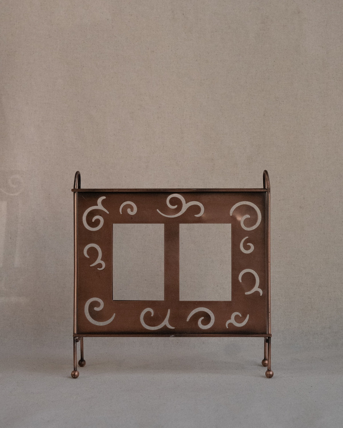 Copper finish dual picture frame with spiral cutouts
