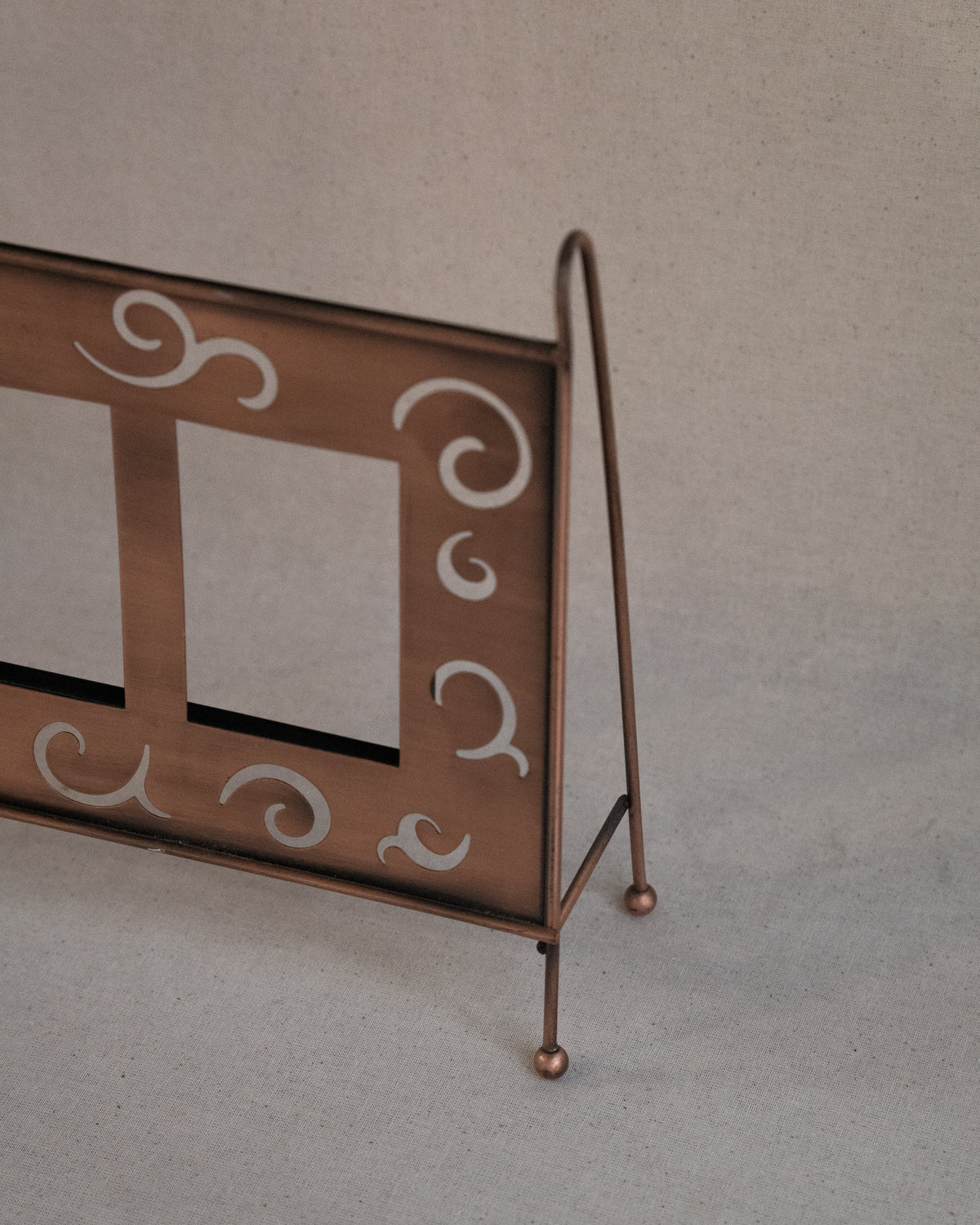 Copper finish dual picture frame with spiral cutouts