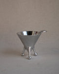 Metal sugar bowl with spoon on raised atomic feet