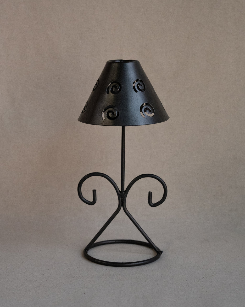 Black metal tea light candle holder with lampshade with spiral cutouts