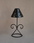 Black metal tea light candle holder with lampshade with spiral cutouts