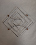 Metal trivet with wooden ball feet