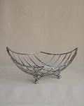 Metal basket with atomic springy feet