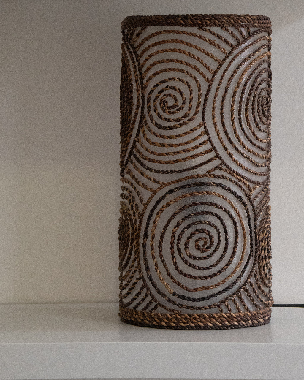 Cylindrical fiberglass and woven spiral table lamp