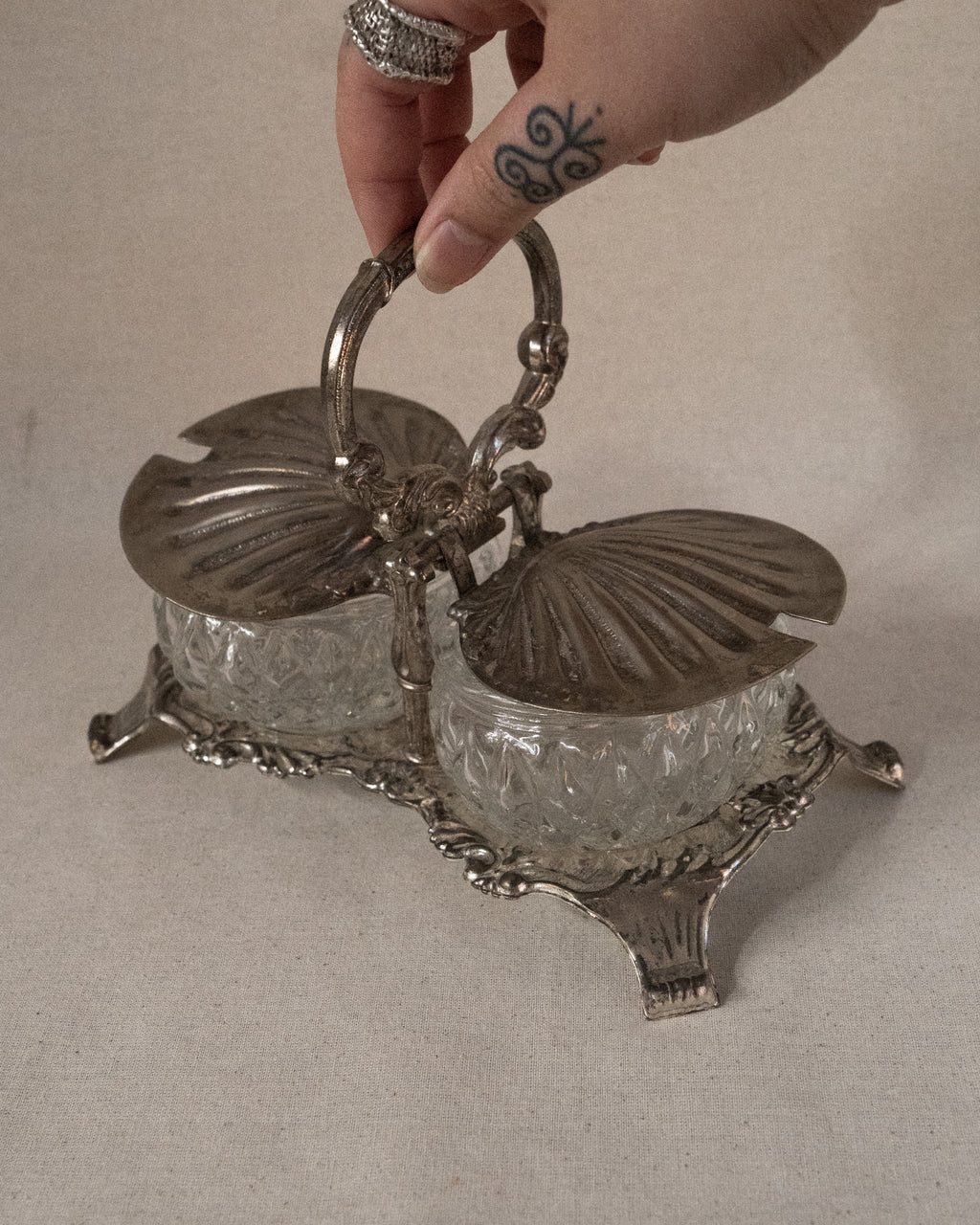 Silver plated shell condiment tray with handle and two glass bowl inserts