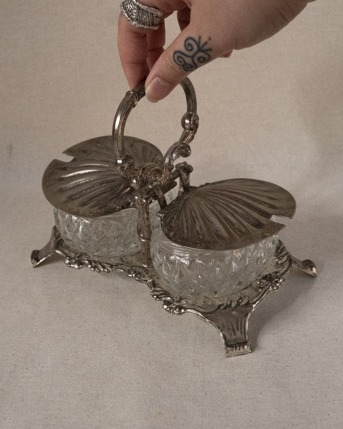 Silver plated shell condiment tray with handle and two glass bowl inserts