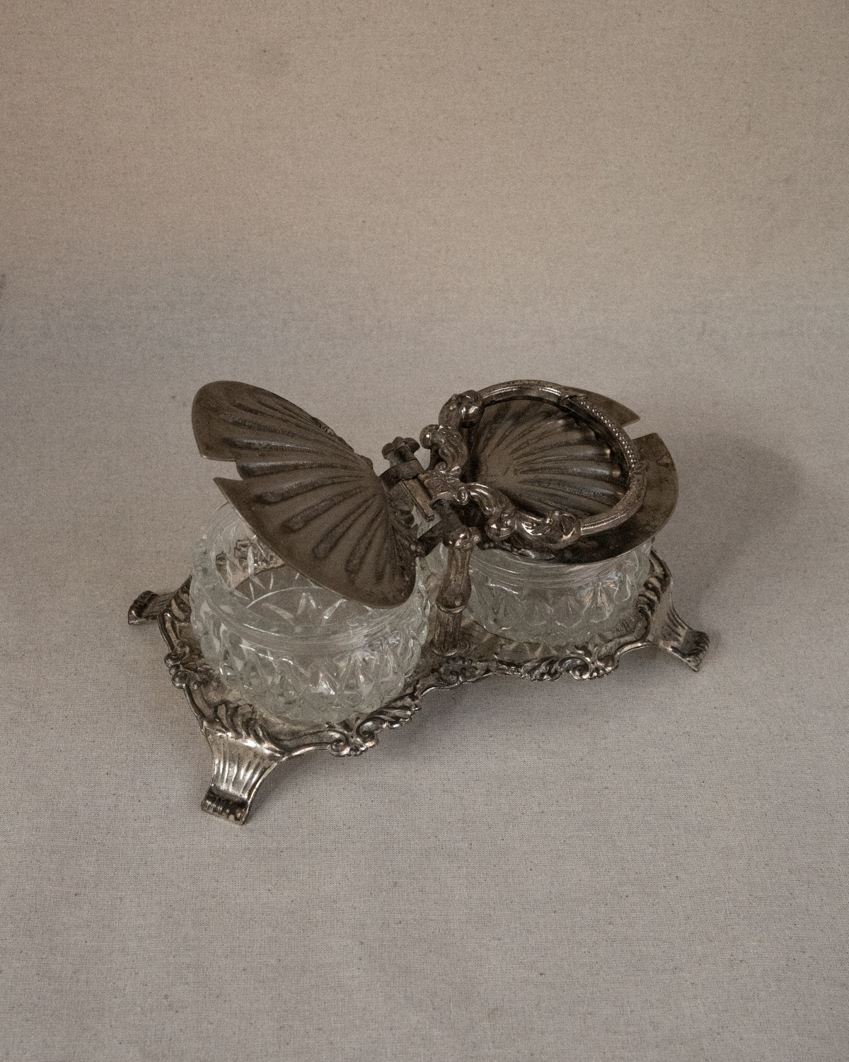 Silver plated shell condiment tray with handle and two glass bowl inserts
