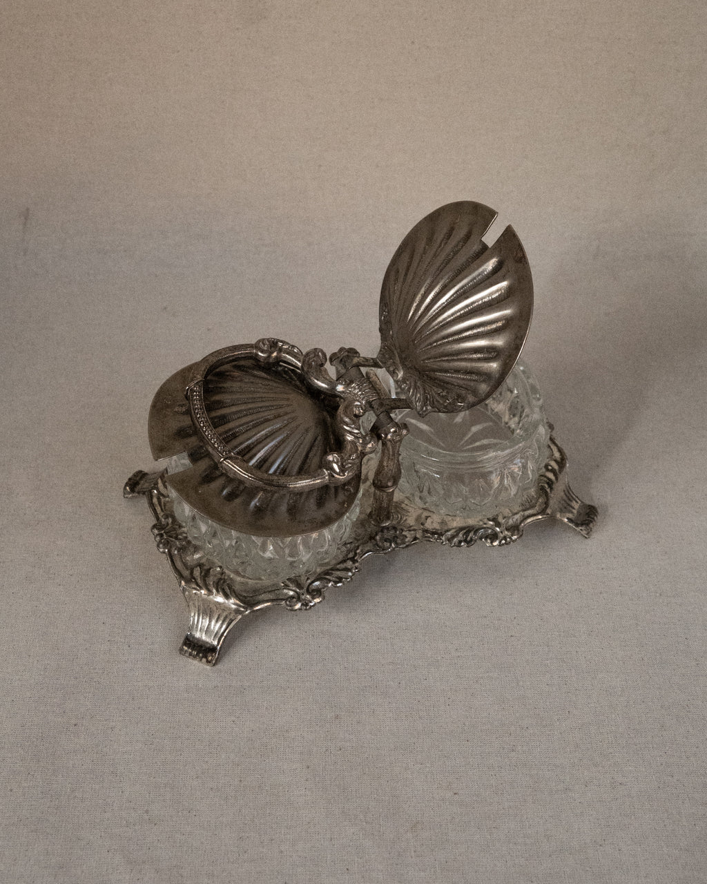 Silver plated shell condiment tray with handle and two glass bowl inserts