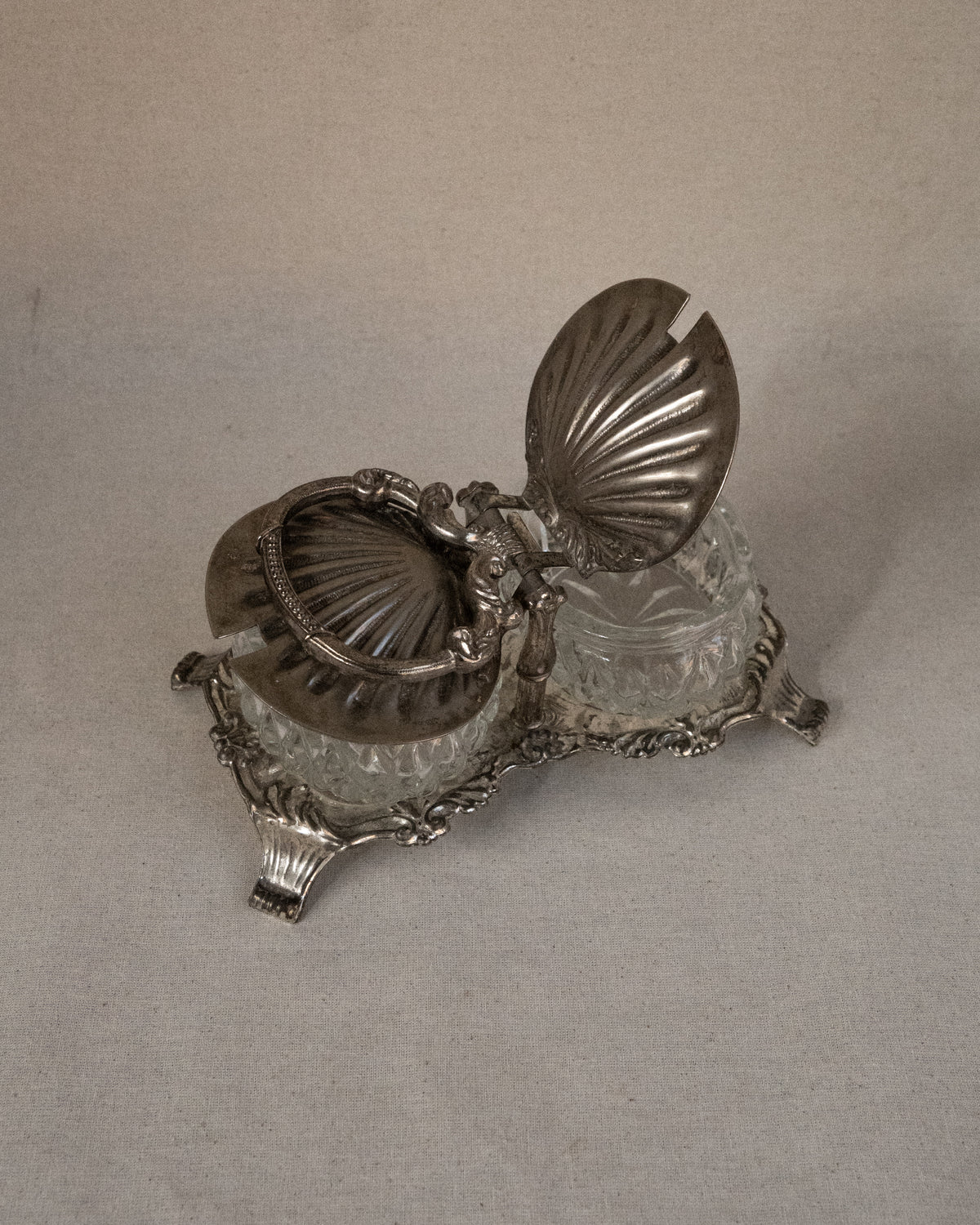 Silver plated shell condiment tray with handle and two glass bowl inserts