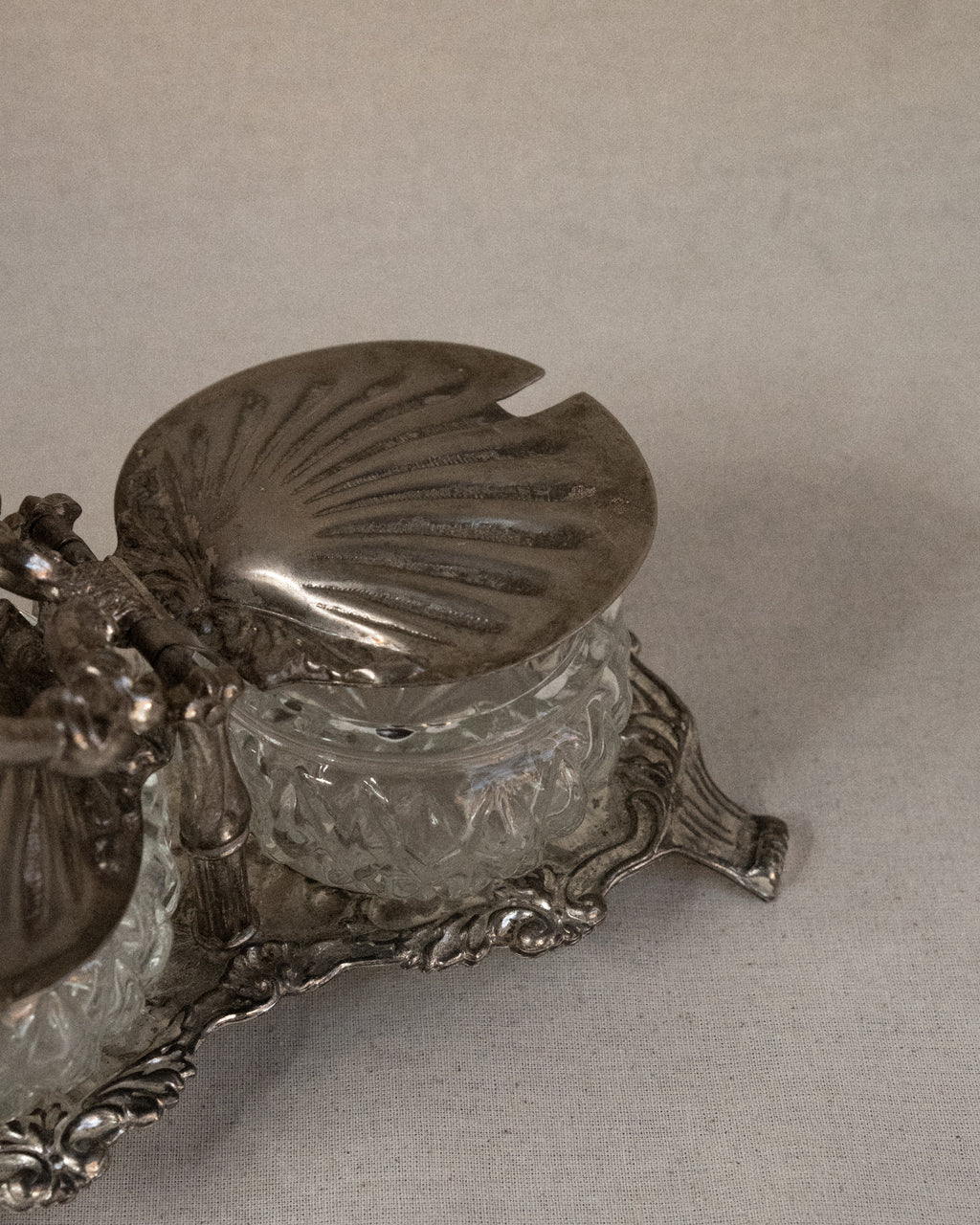 Silver plated shell condiment tray with handle and two glass bowl inserts