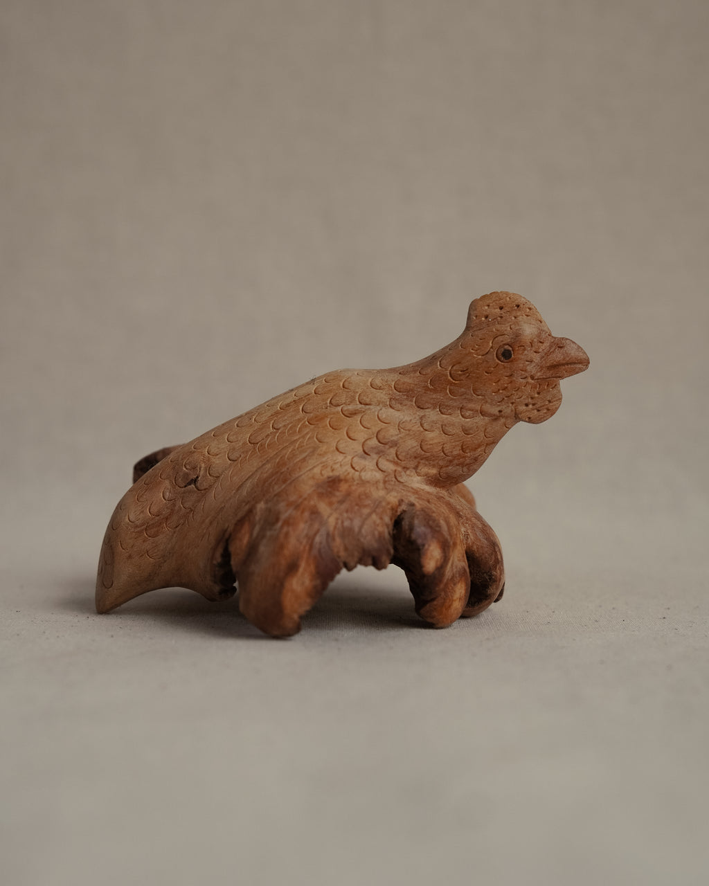 Folk art carved burl wood hen