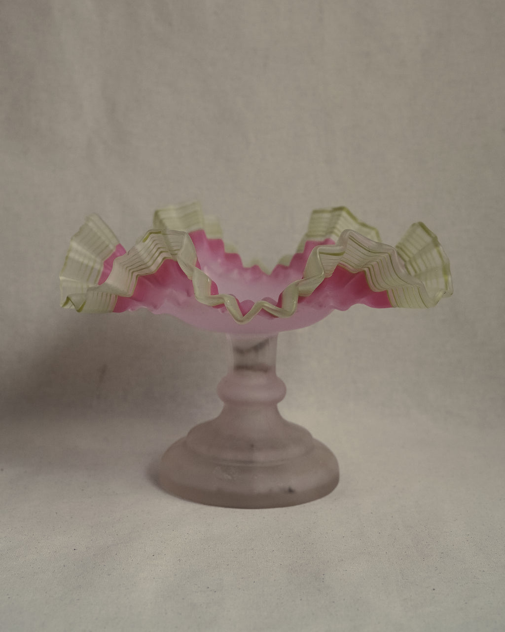 Late 19th century victorian opalescent art glass pedestal compote with pink and yellow/green art glass ruffled edges