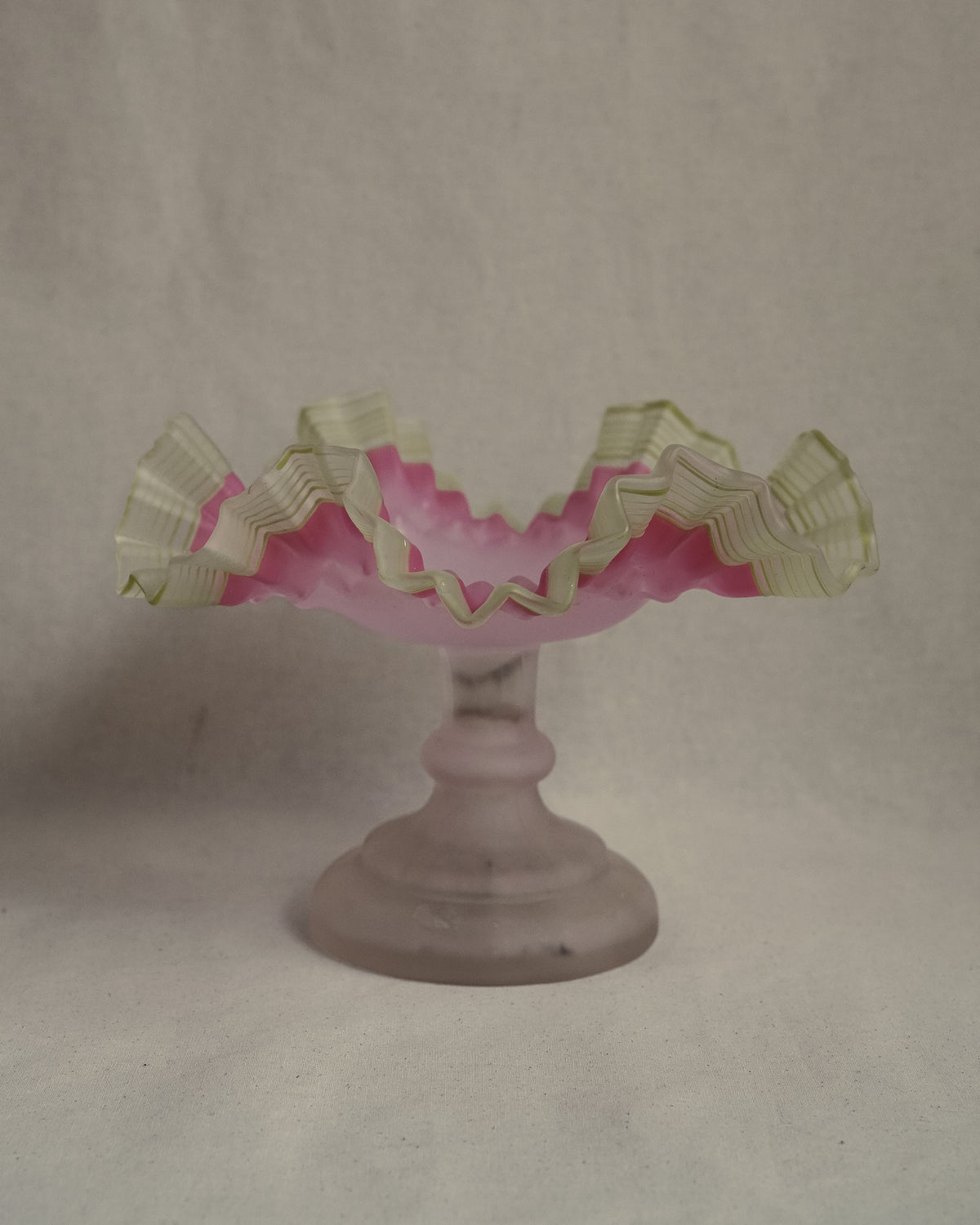 Late 19th century victorian opalescent art glass pedestal compote with pink and yellow/green art glass ruffled edges