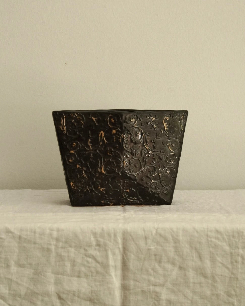 Black ceramic vase with gold accents
