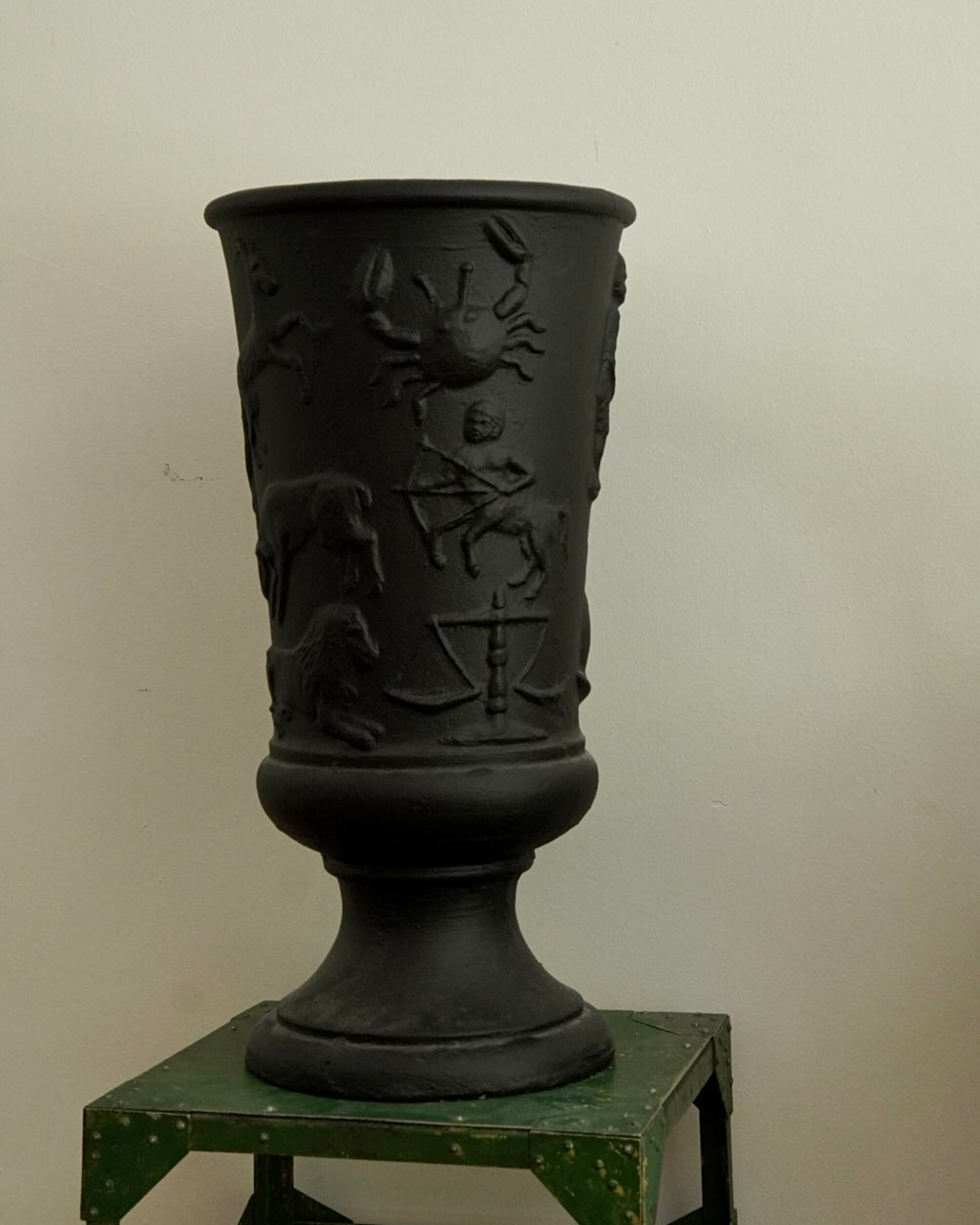 Black concrete vase with horoscope details