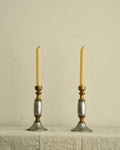 Pair of solid metal candle holders in gold and silver