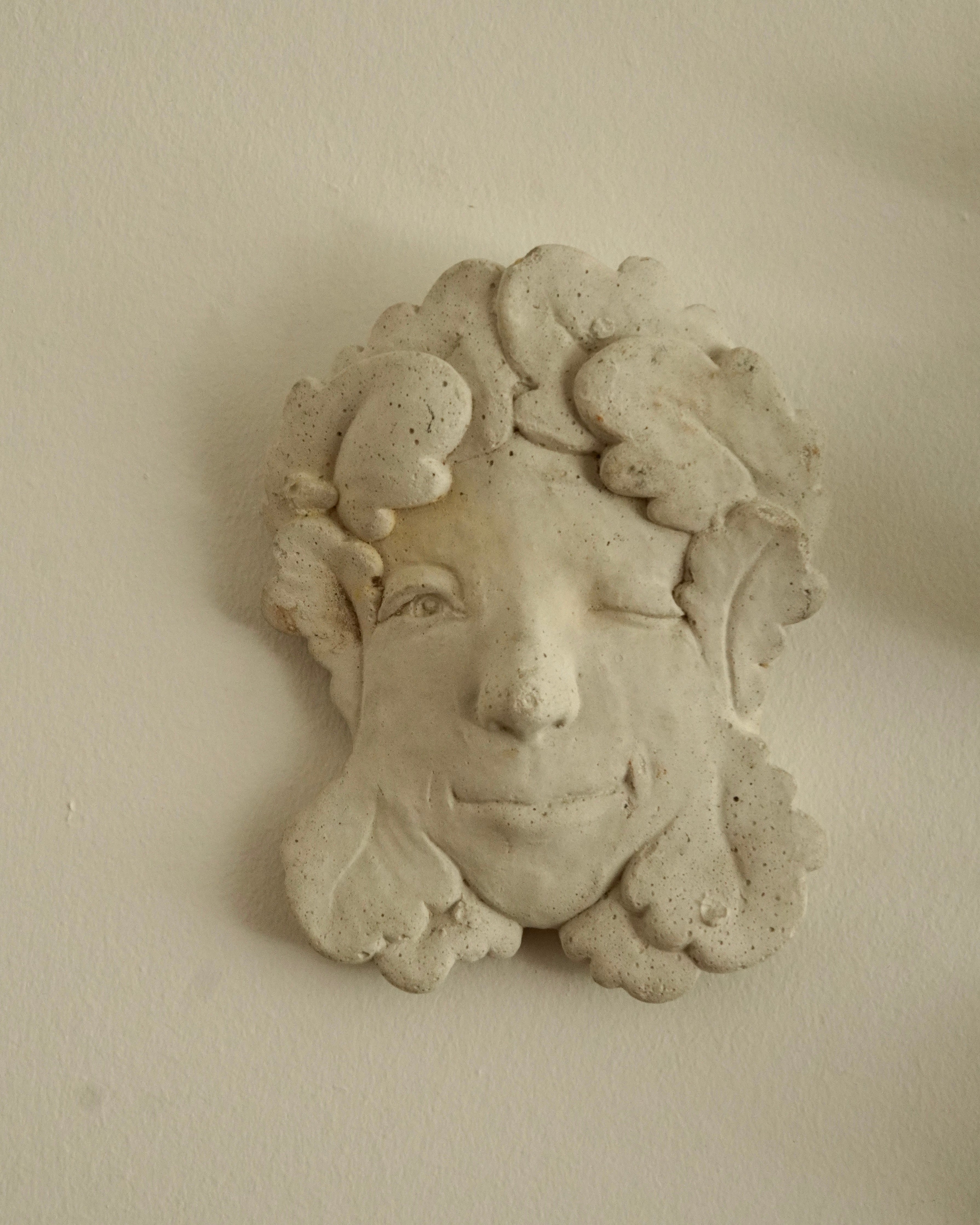 Winking concrete lady wall hanging