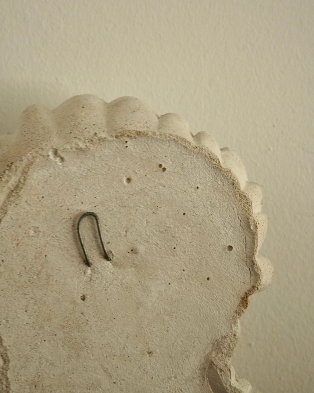 Winking concrete lady wall hanging