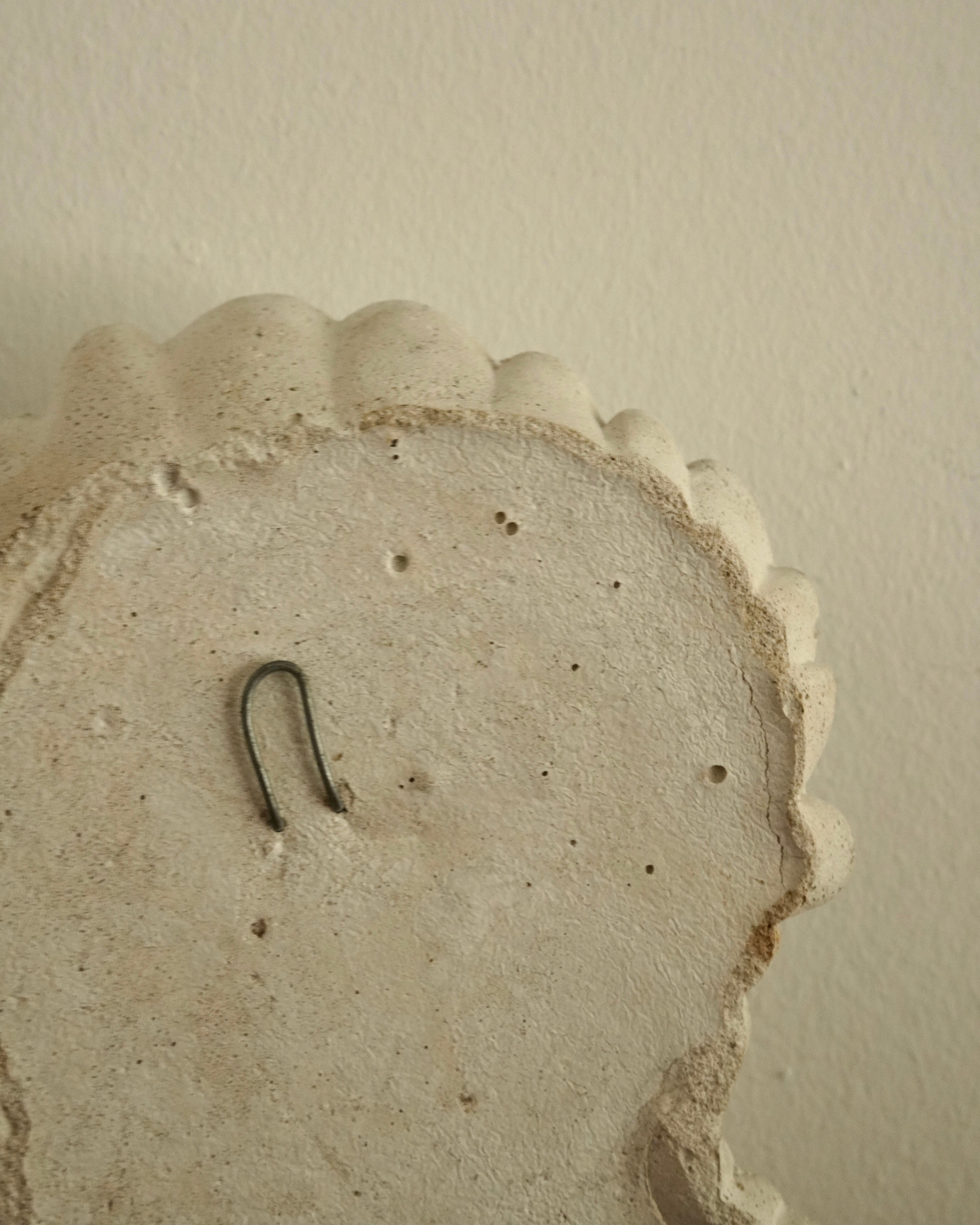 Winking concrete lady wall hanging